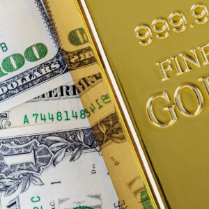 Gold bullion on the background of dollar bills